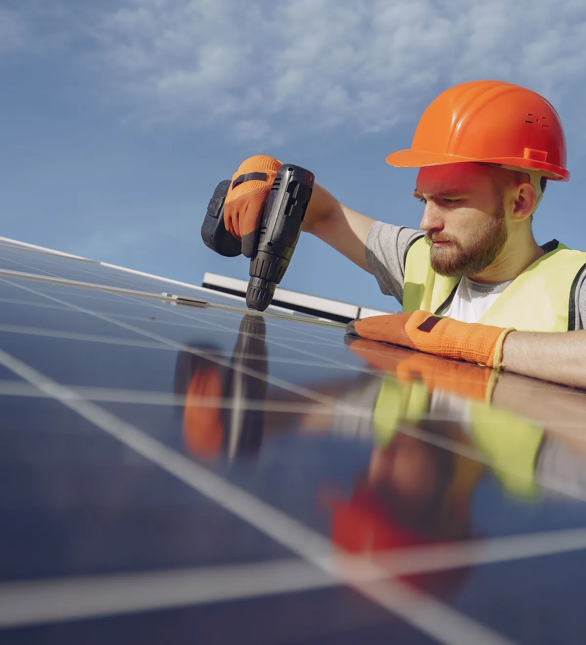 Electrician in hi-vis installing solar panels